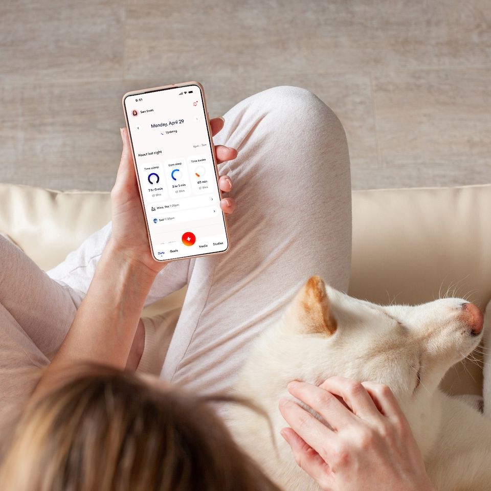 Woman reviewing her health metrics in Amissa app.