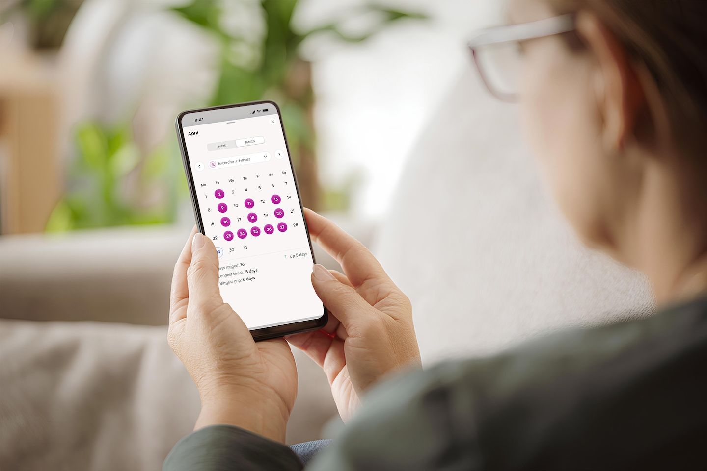 Woman reviews her monthly health data in Amissa app
