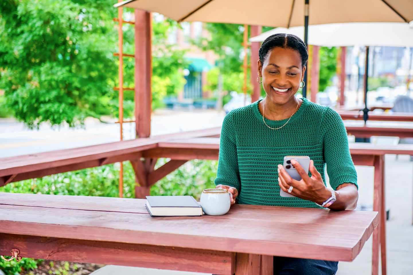 Woman looks at health data on her phone and smiles