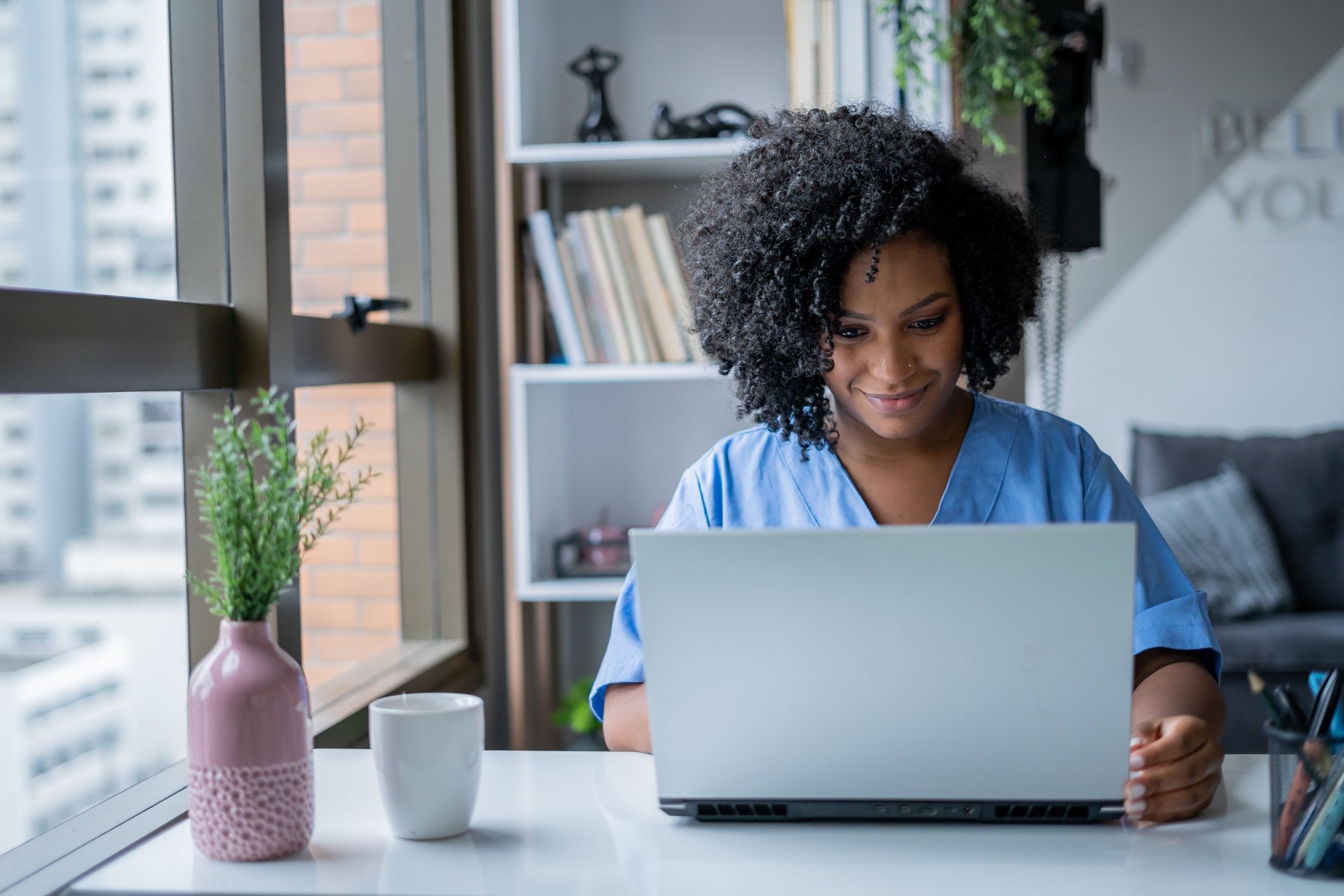 Doctor monitors her patients' treatments from her computer.
