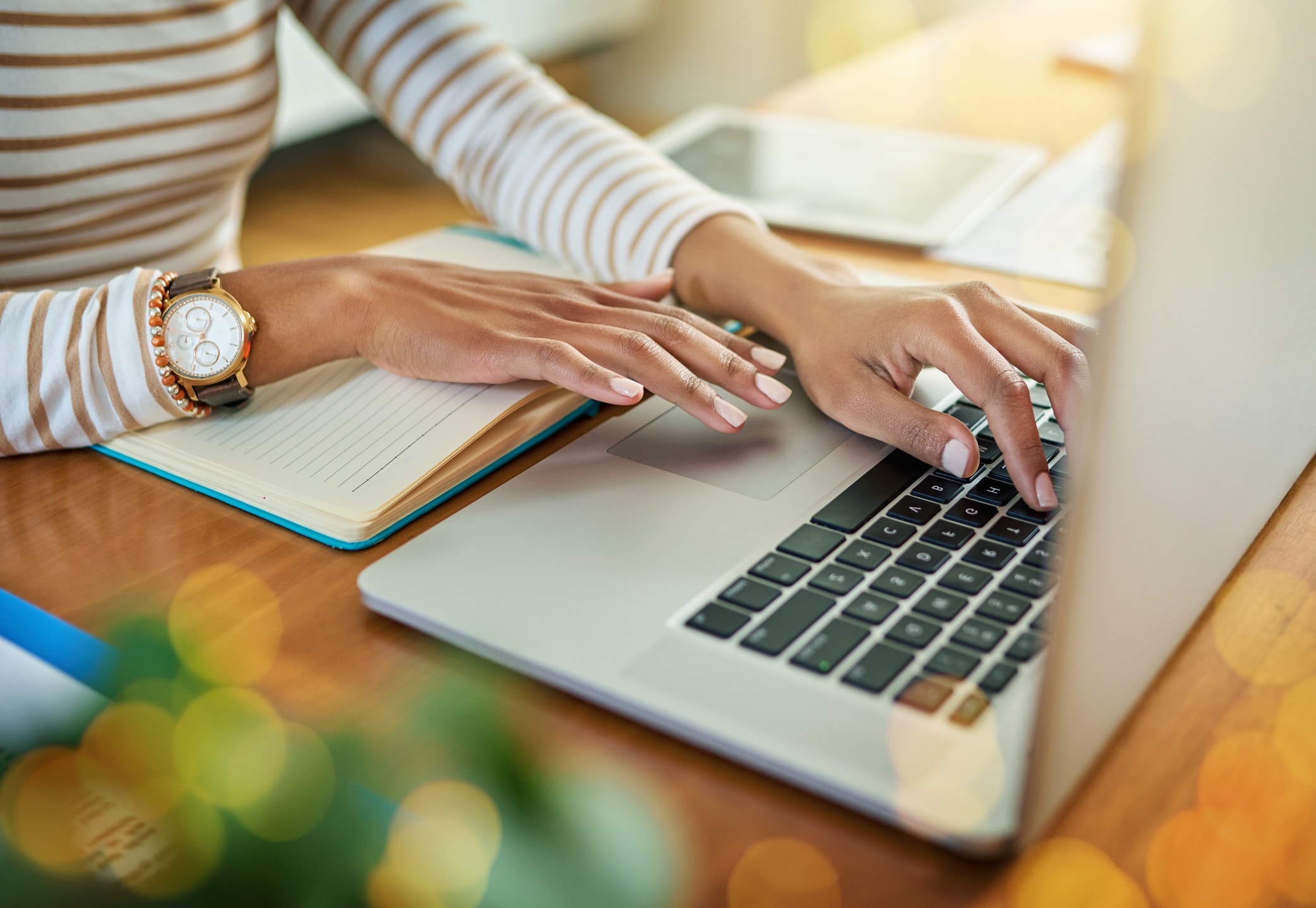 Woman's hands typing on her laptop